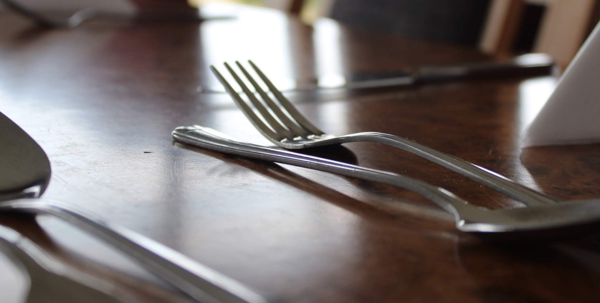 An image of a knife and fork set on a table