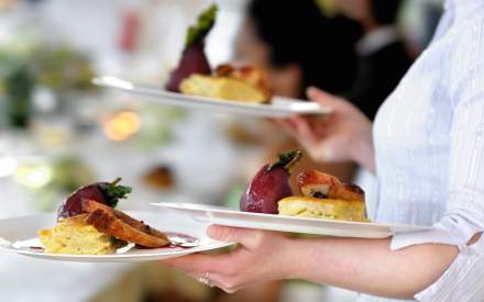 Image of someone serving food at Cedars Bar, Overstone Park Resort