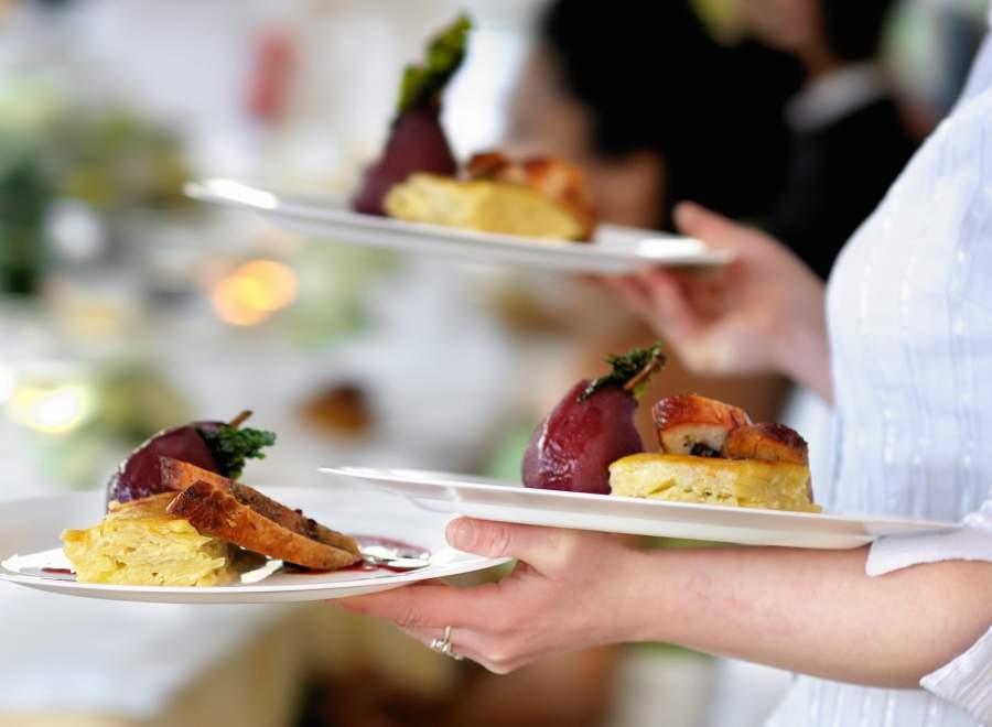 Image of someone serving food at Cedars Bar, Overstone Park Resort