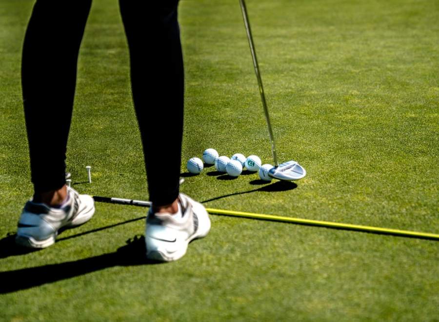 A picture of someone practising their putting at Overstone Park Resort's golf course